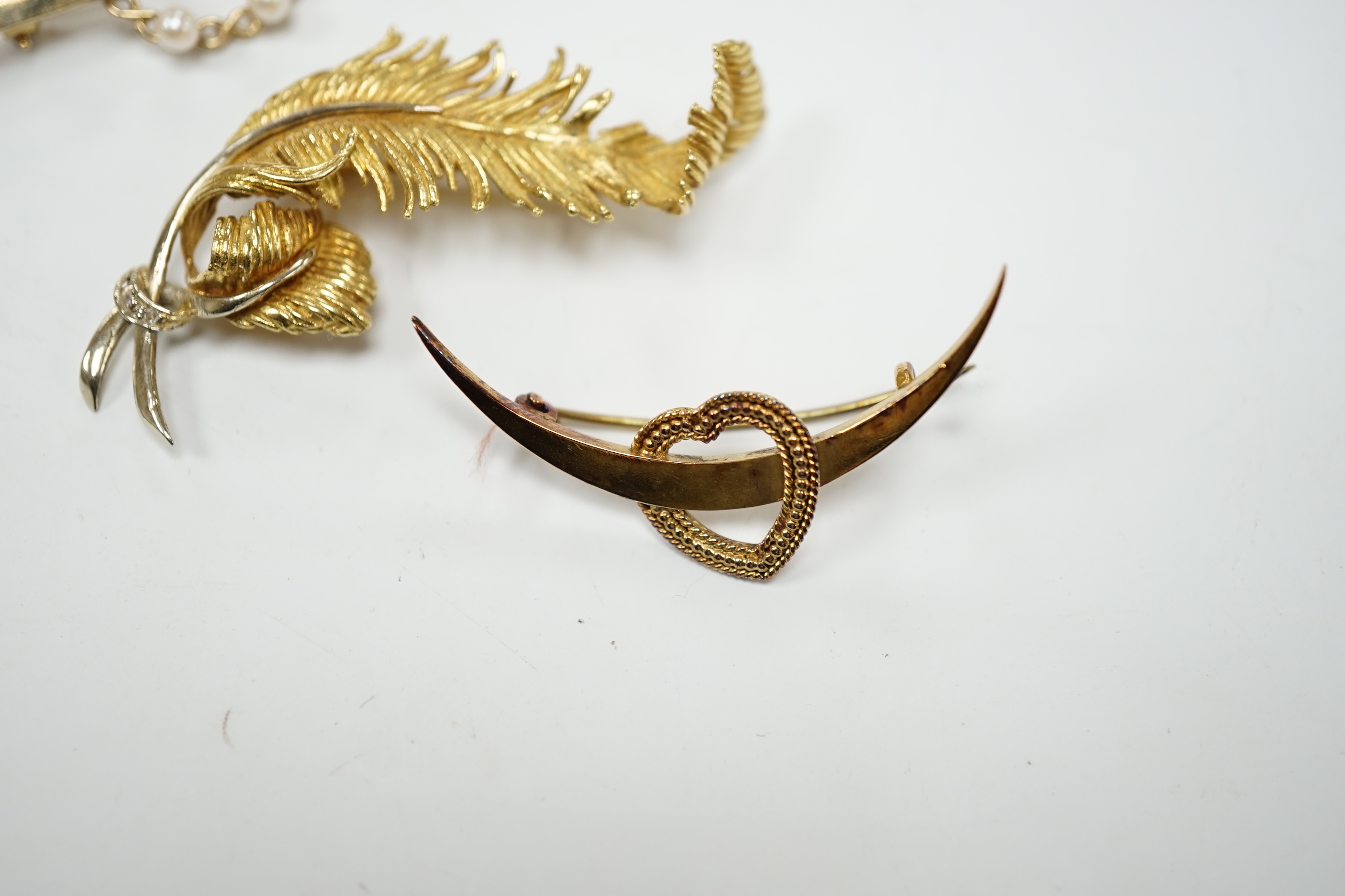 A 1960's 18ct gold and diamond chip set scrolling fern brooch by Cropp & Farr, 52mm, an 18ct heart and crescent brooch, gross weight 11.9 grams and a 9ct and seed pearl bar brooch, gross weight 2.8 grams.